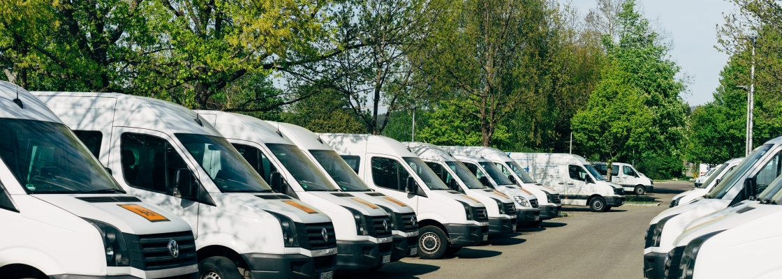 A row of business vans in a parking lot